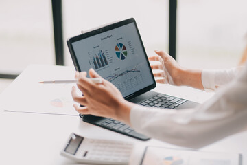 Portrait of young asian woman working with laptop at home office.