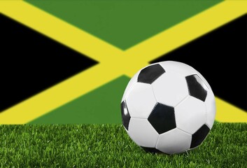 Obraz premium The Jamaica flag and soccer ball on the green grass
