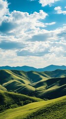 Fototapeta premium A breathtaking view of rolling green hills beneath a vibrant blue sky dotted with fluffy clouds, capturing the essence of tranquility and nature.