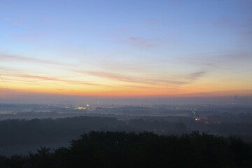 Obraz premium View from the Halde Norddeutschland spoil tip onto the Lower Rhine and the western Ruhr district at dawn, Neukirchen, North Rhine-Westphalia, Germany, Europe