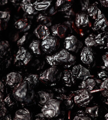 Dried blueberries as background. Close-up