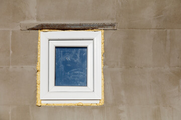 Fototapeta premium A window with a blue reflection on the wall