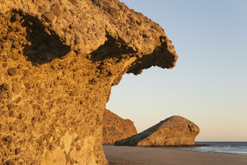 Fossilized lava tongues and walls at the beach Playa del Monsul, Nature Reserve Cabo de Gata-Nijar,...