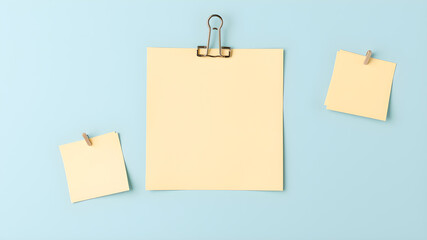 Paper notes with clip on light blue background, top view. Space for text. Generative AI