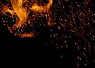 A black background with orange sparks flying in the air