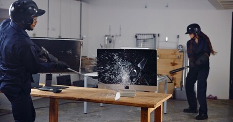 Computer, baseball bat and people in rage room for frustrated, anger management and stress relief. Weapon, safety gear and screen with friends in smash center for demolition and cathartic therapy