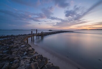 Obraz premium A beautiful cove with crystal clear blue water and sandy beaches surrounded by cliffs and greenery.