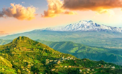 beautiful panorama of Etna vulcano in Italy, Sicily, Taormina to mountain landscape with white snow peak and green hills and valleys arround