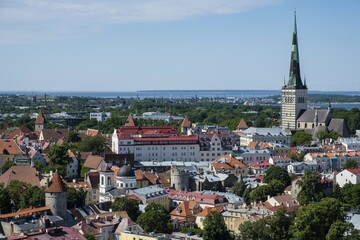 City view with St Olaf's Church or Oleviste Kirik and harbour at the Baltic Sea, seen from the tower of Toomkirik Cathedral, Tallinn, Estonia, Europe