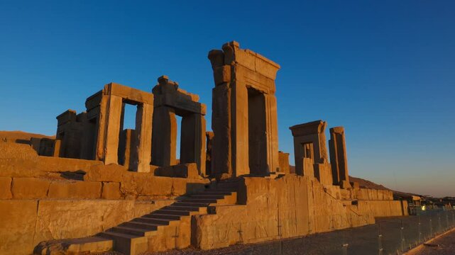 The Tachara Palace in Persepolis, Iran, is renowned for its scenic ruins, which are illuminated by sunset. The site was the ceremonial capital of the Achaemenid Empire. UNESCO World Heritage Site