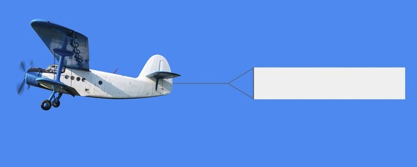 biplane with a banner in the sky © Frank Peters/imageBROKER