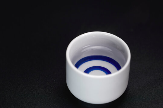 Japanese style sake drinking vessel filled with sake, steam