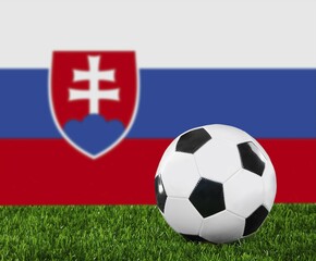 Obraz premium The Slovakia flag and soccer ball on the green grass
