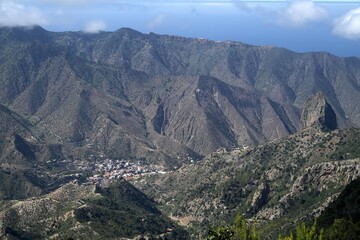 Fototapeta premium View from the Mirador de Vallehermoso on valley and Vallehermoso between mountains, Garajonay National Park, District Agulo, La Gomera, Canary Islands, Spain, Europe