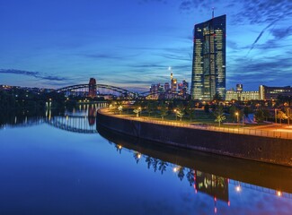 European Central Bank, ECB, at dusk in front of the illuminated skyline, roundabout at the Osthafen...
