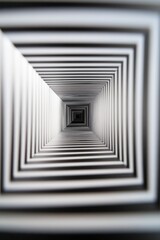 Obraz premium A black and white photo of a tunnel with a white stripe. The photo is blurry and the tunnel is very long