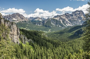 Fototapeta premium Mountain landscape with spruce forests near Cortina d'Ampezzo, view from the 5 Torri Des-Alpes-Areal, left at the back Monte Cristallo, Sorapis group on the right, near Cortina d'Ampezzo, Veneto, Dolomites, Italy, Europe