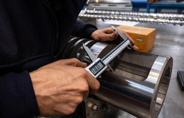 Professional quality control inspector conduct safety inspection on steel machinery and manufacturing process. Factory engineer or operator make