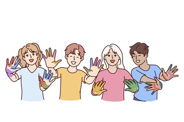 Childrens artists with palms smeared with paints rejoice at opportunity to draw and express creativity. Happy hildrens boys and girls in primary school are happy thanks to art lessons