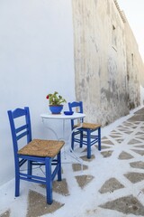 Table and chairs in an alley, Arkasa, Karpathos, Dodecanese, South Aegean, Greece, Europe