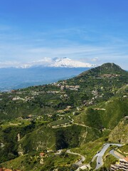Fototapeta premium View of Taormina, snowy volcano Etna at back, Sicily, Italy, Europe