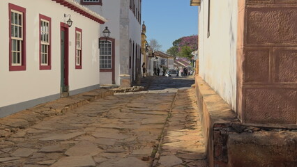 Walking through colorful cobblestone street in colonial Brazilian town