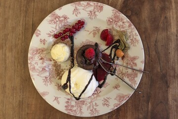 Dessert, chocolate cake on a plate garnished with fruits, Germany, Europe
