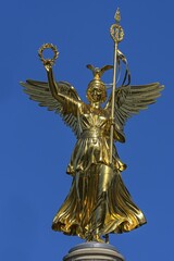 Fototapeta premium Bronze sculpture of Victoria on the Victory Column, inaugurated in 1873, blue sky, Berlin, Germany, Europe