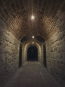 Old wine cellar tunnel at the Hincesti winery underground of the Manuc Bei mansion in Hancesti, Moldova. Traditional moldavian rural subterrane stone vault reconstructed with modern motif. Creepy dark details