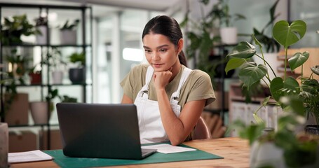 Laptop, online order and thinking with woman in flower shop for sale of floral arrangements....