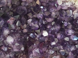 purple crystals of quartz as a background, closeup of photo