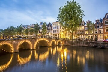 Fototapeta premium Historical houses by the canal at dusk, Amsterdam, Netherlands