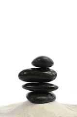 Hot Stones stacked on white sand