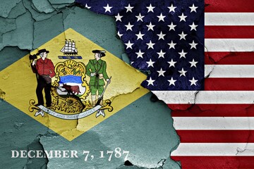 Flags of Delaware and USA painted on cracked wall