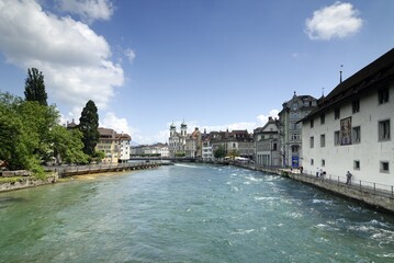 Lucerne - the reuss river and a church in the background - Switzerland, Europe.