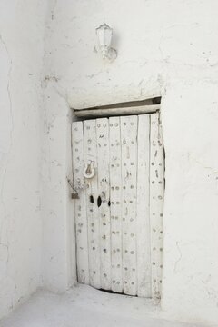 Antiquity white entrance door made out of wood in Old Town of Ghadames Lybia