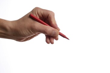 Hand with a red pen on a white background