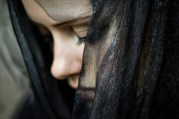 Close-up of a mourning veil on a grieving person&rsquo;s face