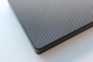 Textured pattern of parallel lines on the surface of a plastic panel 
