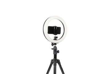 A professional tripod-mounted LED light surrounds a smartphone, symbolizing modern content creation tools, isolated on a transparent background