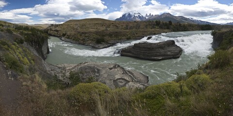 Panoramic view of a waterfall of the glacial river Rio Paine, Torres del Paine National Park, Lake...