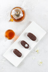 Homemade glazed curd cheese or syrok with chocolate and cup of tea. The concept of proper nutrition. Vertical orientation, top view.