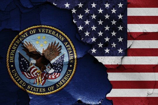 Flags of Department of Veterans Affairs and USA painted on cracked wall