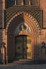 Side entrance of the neo-Gothic St. Paul's Church, built 1863-1869, with a relief of Christ,...