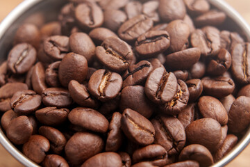 Fototapeta premium Roasted Arabica coffee beans in a metal cup.
