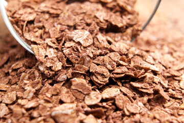 Rolled oat grains with cocoa powder. Raw nutritious morning porridge ingredient