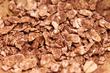 Oatmeal flakes with cocoa powder in wooden bowl. Dry ingredient
