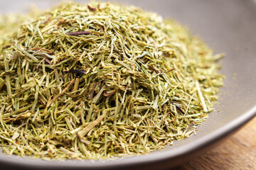Horsetail dried leaves in a bowl. Medicinal herbal tea ingredient.