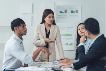 Business Meeting: A professional businesswoman leads a discussion in a modern office setting, surrounded by colleagues during a board meeting. The image exudes confidence and focus.