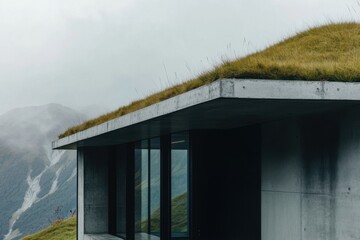 Fototapeta premium Modern architectural design featuring a green roof on a minimalist building in a mountainous region under cloudy skies enhancing natural surroundings